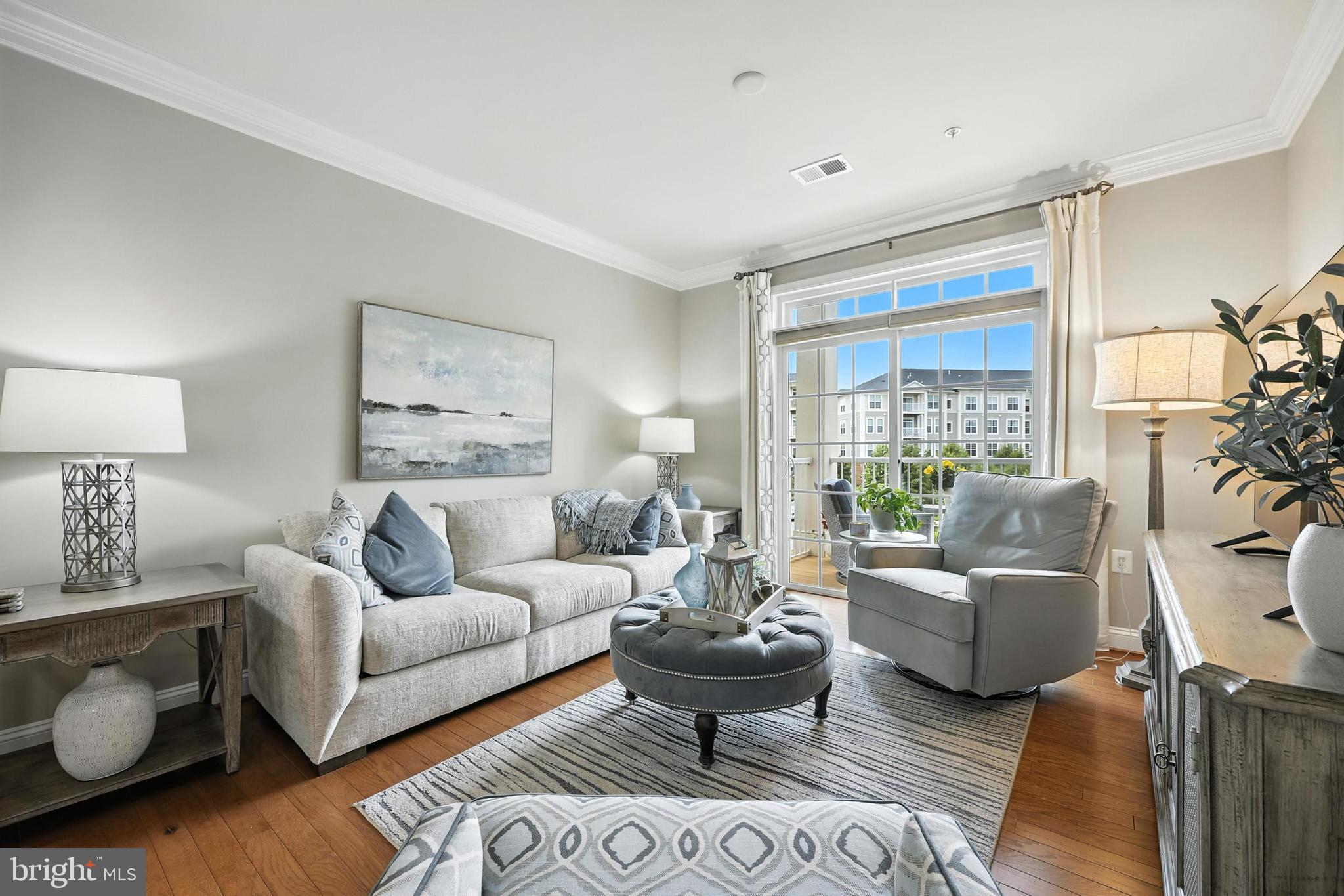 3910 Doc Berlin Drive, Unit 21 Silver Spring, MD 20906 - Photo 5 of 27 a living room with furniture wooden floor and a large window