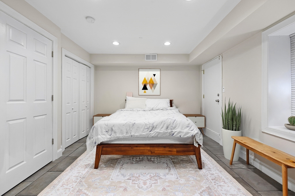 110 Chelsea Street, Unit 1 Boston, MA 02128 - Photo 8 of 12 a bed room with a bed and a potted plant