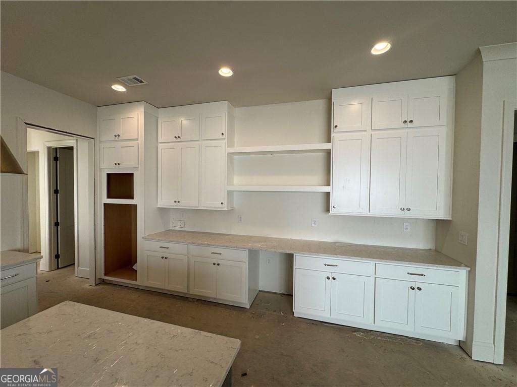 224 Suwanee Avenue Suwanee, GA 30024 - Photo 3 of 9 a kitchen with white cabinets and refrigerator