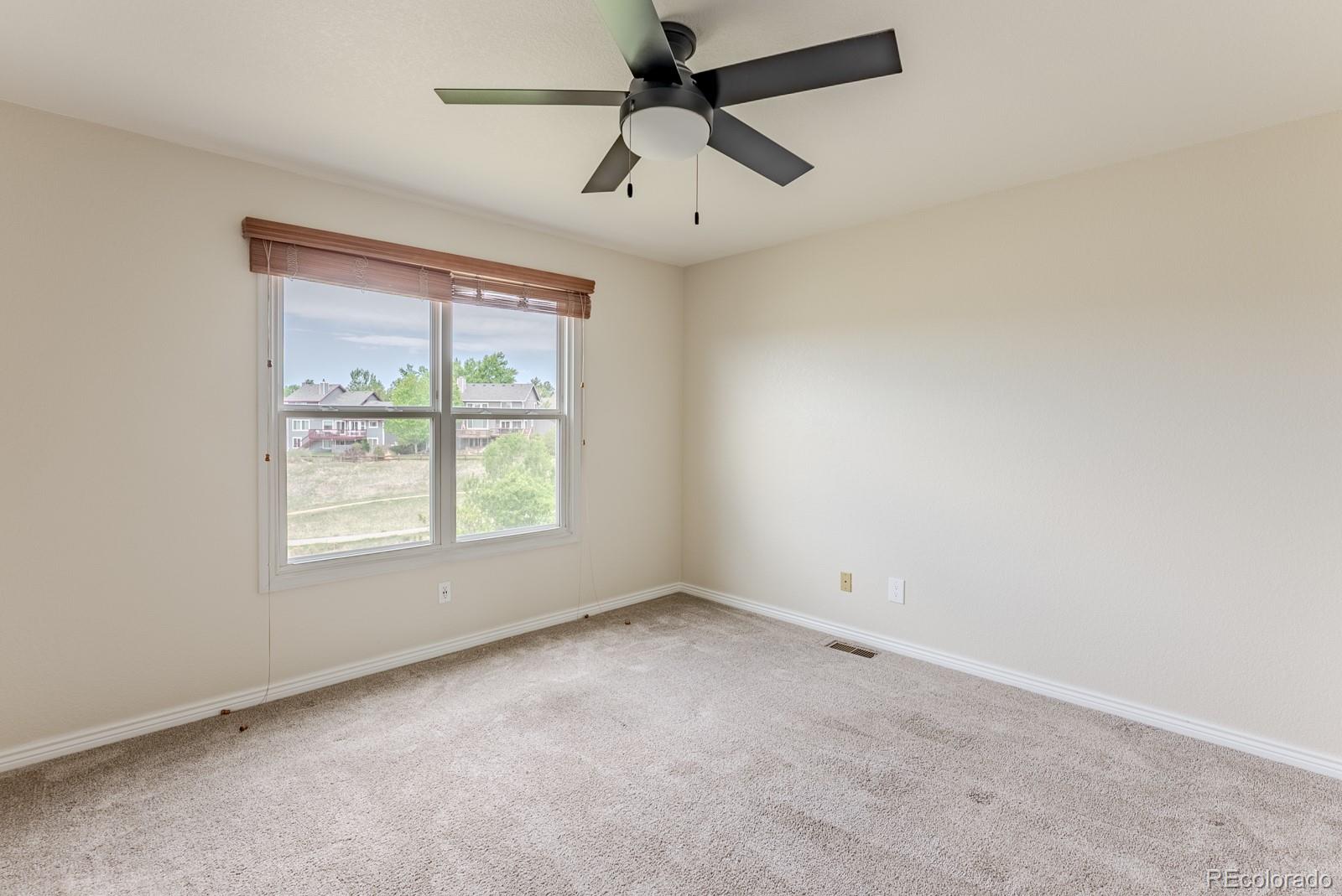 1914 Terrace Drive Highlands Ranch, CO 80126 - Photo 31 of 47 an empty room with a window and a fan