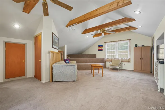 a view of a livingroom with furniture and a ceiling fan