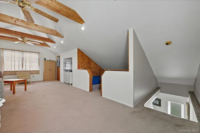 a view of a livingroom with furniture and stairs