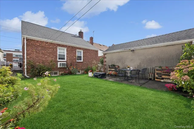 a view of a backyard with plants and a patio