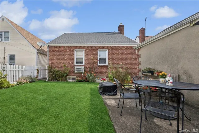 a backyard of a house with table and chairs