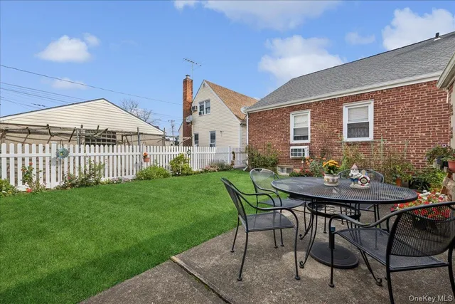 a view of a house with backyard and sitting area