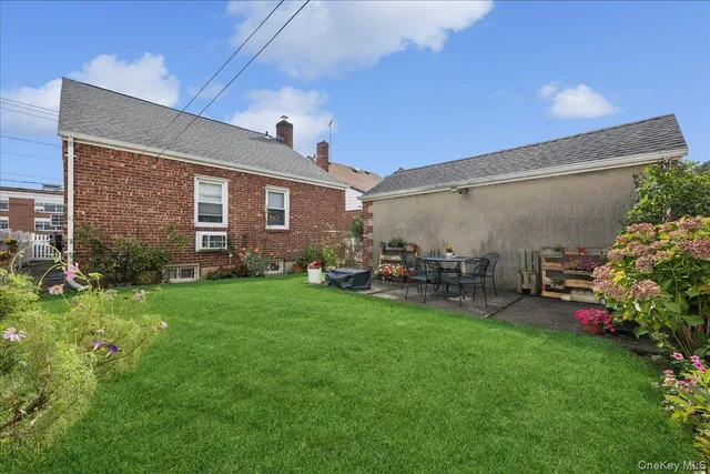 a view of a backyard with plants and a patio