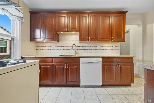 a kitchen with stainless steel appliances granite countertop a sink stove and cabinets