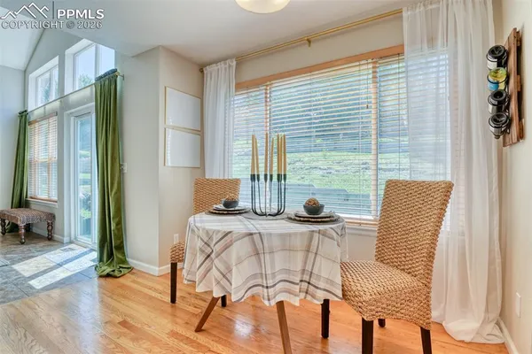 a kitchen with stainless steel appliances kitchen island wooden floors and white cabinets