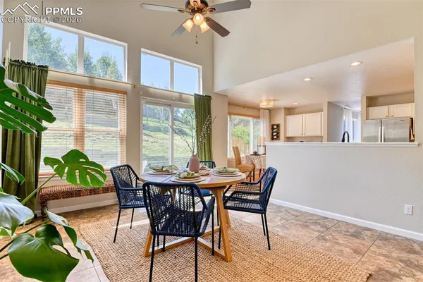 a dining room with furniture and wooden floor