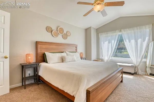 a bedroom with a bed and painting on the wall