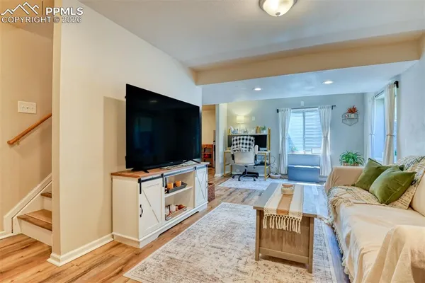 a living room with a bed and furniture