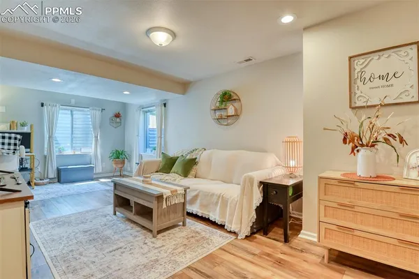 a view of a livingroom with furniture and a window