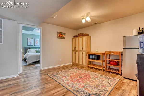 a view of a bedroom with wooden floor