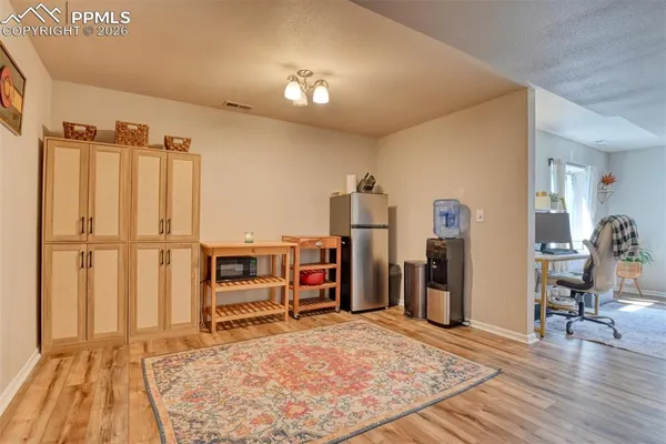 a view of a bedroom with wooden floor and closet