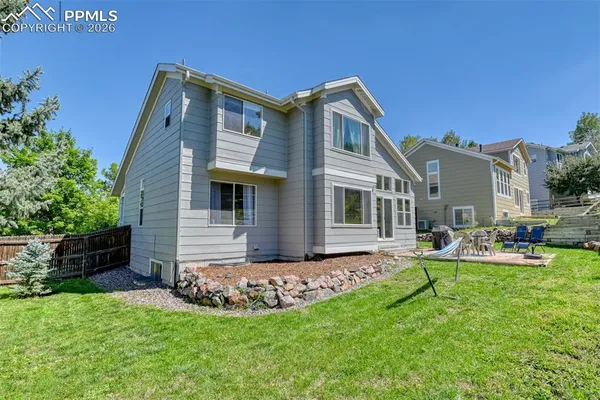 a view of a backyard with plants and outdoor seating