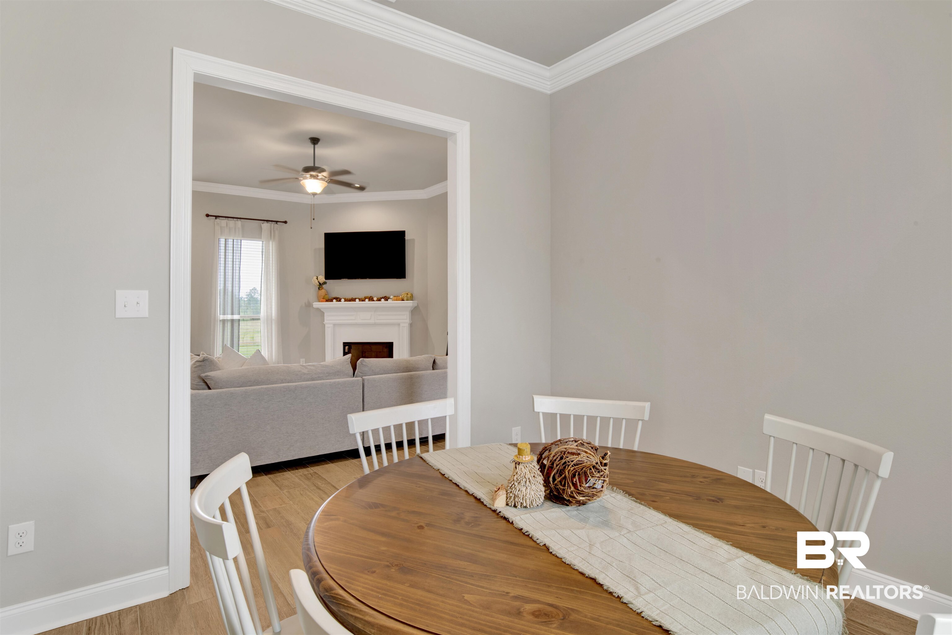 30770 Marcel Boulevard Spanish Fort, AL 36527 - Photo 7 of 23 Dining space with crown molding, ceiling fan, and light wood-type flooring
