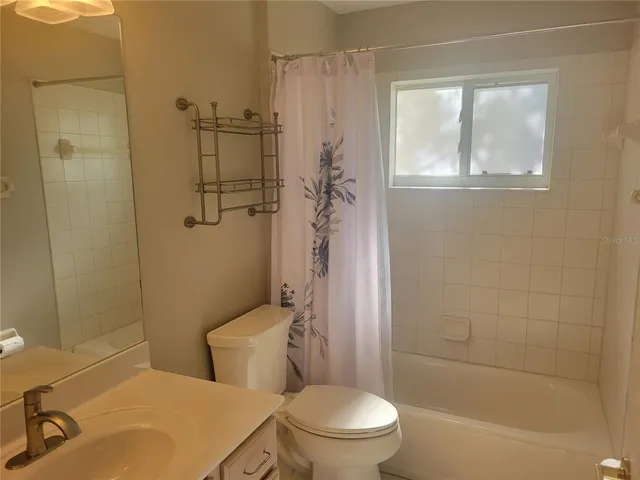 a kitchen with kitchen island granite countertop a sink and cabinets