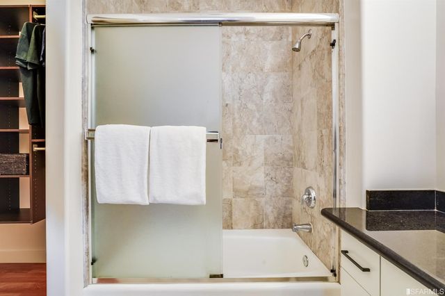 a bathroom with a shower and a sink