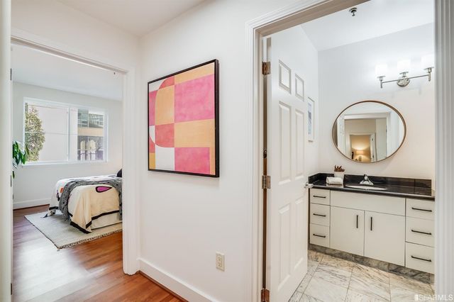 a hall way with furniture a mirror and a window