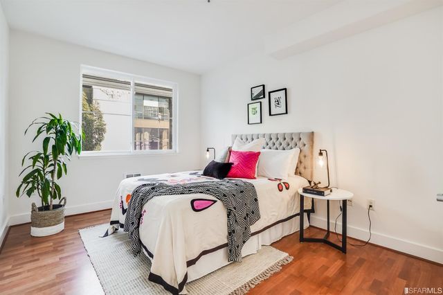a bedroom with a bed and a potted plant