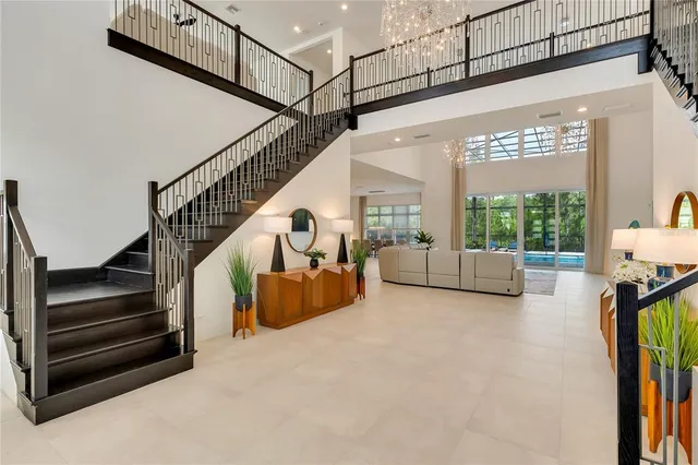 a living room with furniture and a chandelier