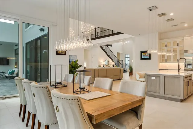 a large white bathroom with a double vanity sink a mirror and a bathtub