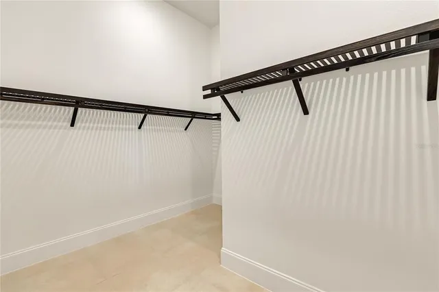 a bedroom with a bed and a lamp on the dresser