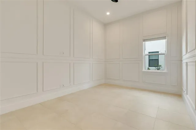 a bathroom with a granite countertop sink a bathtub and next to a window
