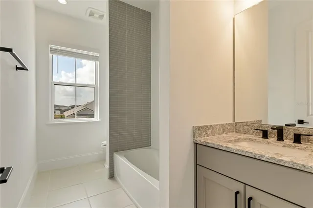 a front view of a house with a yard and potted plants