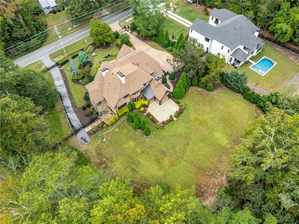 16050 South Thompson Road Milton, GA 30004 - Photo 11 of 72 an aerial view of residential house with yard and swimming pool