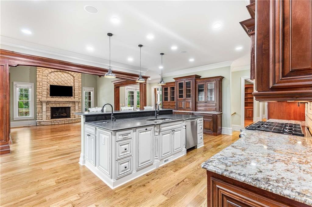 16050 South Thompson Road Milton, GA 30004 - Photo 30 of 72 a large kitchen with stainless steel appliances granite countertop a stove and a wooden cabinets
