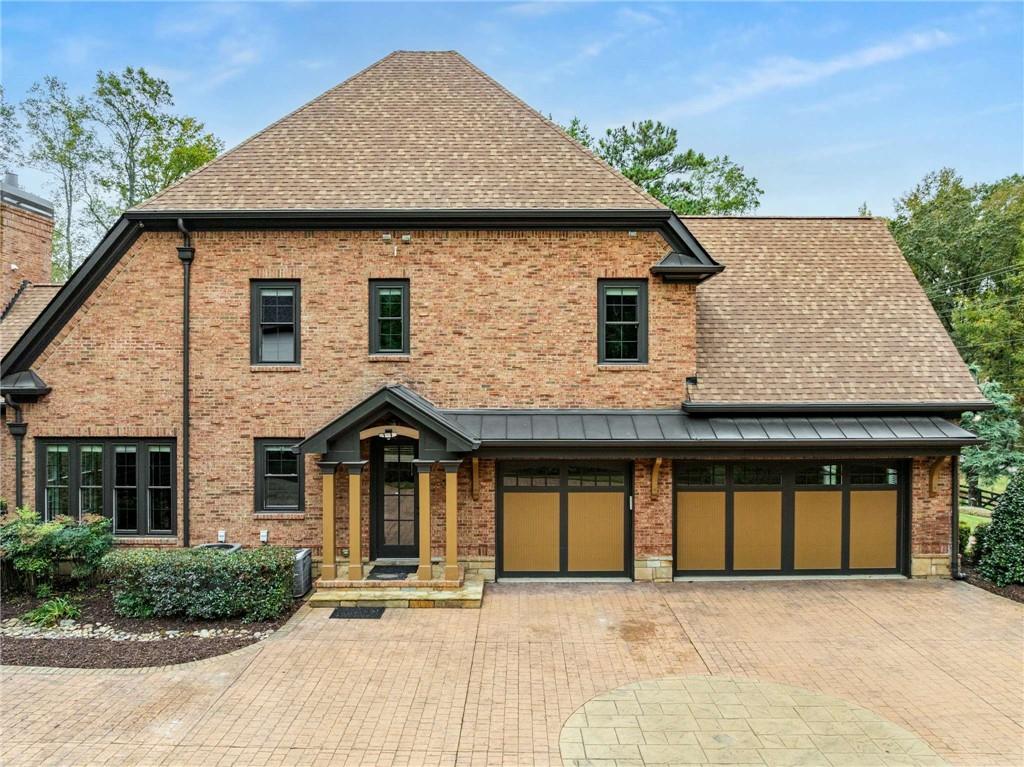 16050 South Thompson Road Milton, GA 30004 - Photo 3 of 72 a front view of a house with garden