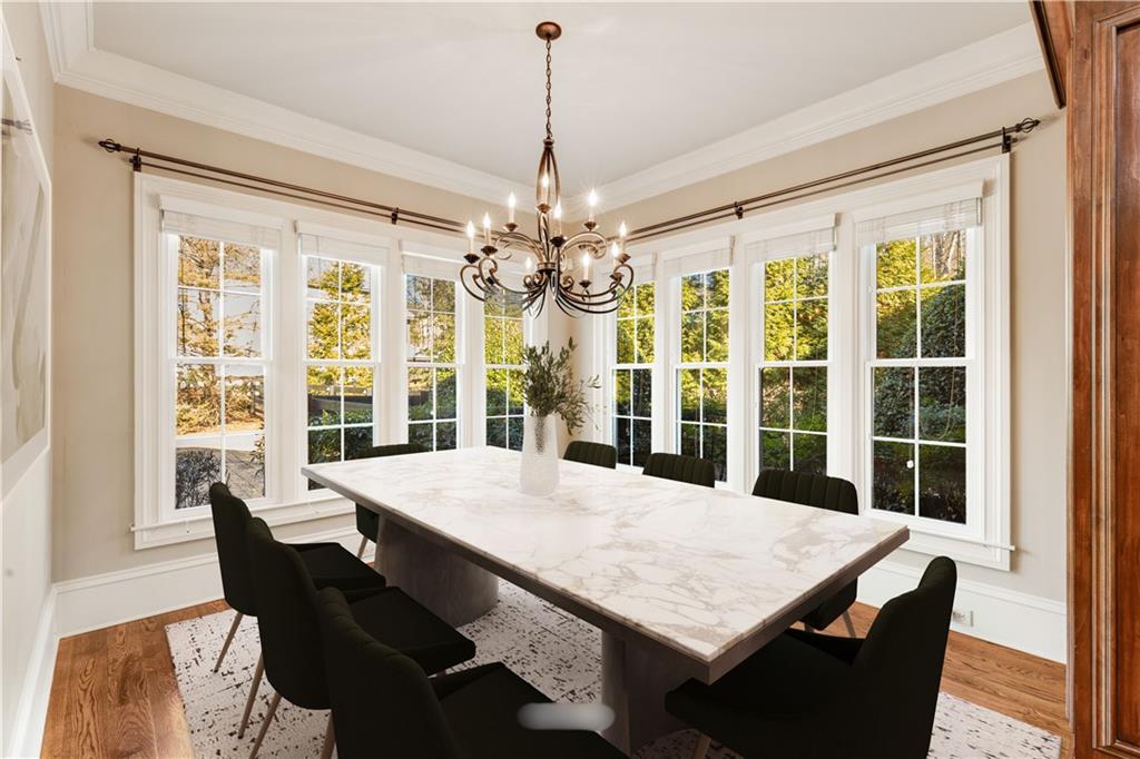 16050 South Thompson Road Milton, GA 30004 - Photo 32 of 72 a view of a dining room with furniture large windows and wooden floor