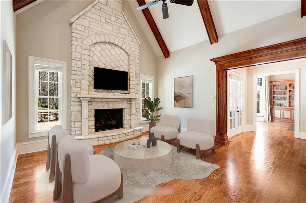 16050 South Thompson Road Milton, GA 30004 - Photo 34 of 72 a living room with furniture a flat screen tv and a fireplace