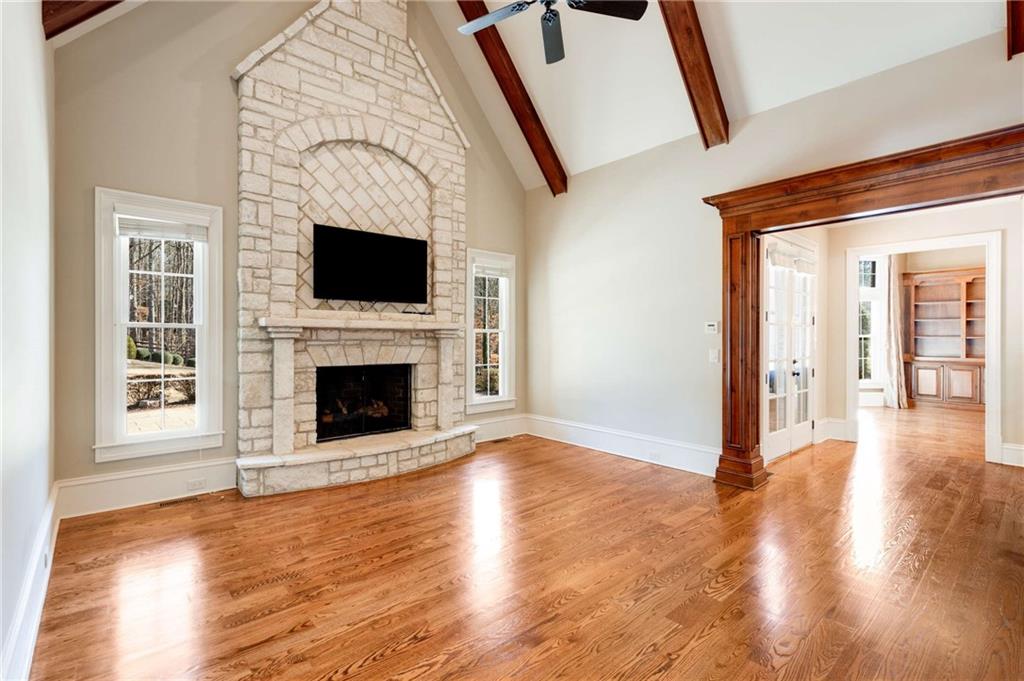 16050 South Thompson Road Milton, GA 30004 - Photo 35 of 72 a view of a livingroom with a fireplace wooden floor and staircase