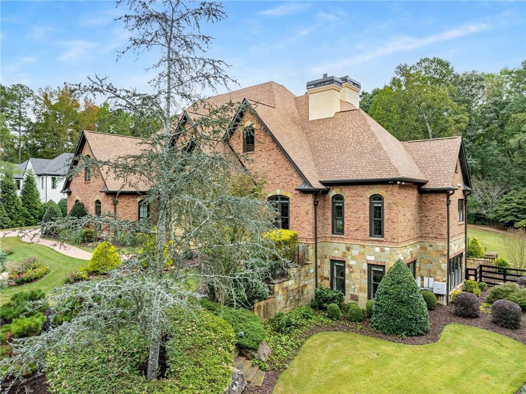 16050 South Thompson Road Milton, GA 30004 - Photo 4 of 72 a aerial view of a house with a yard and large trees