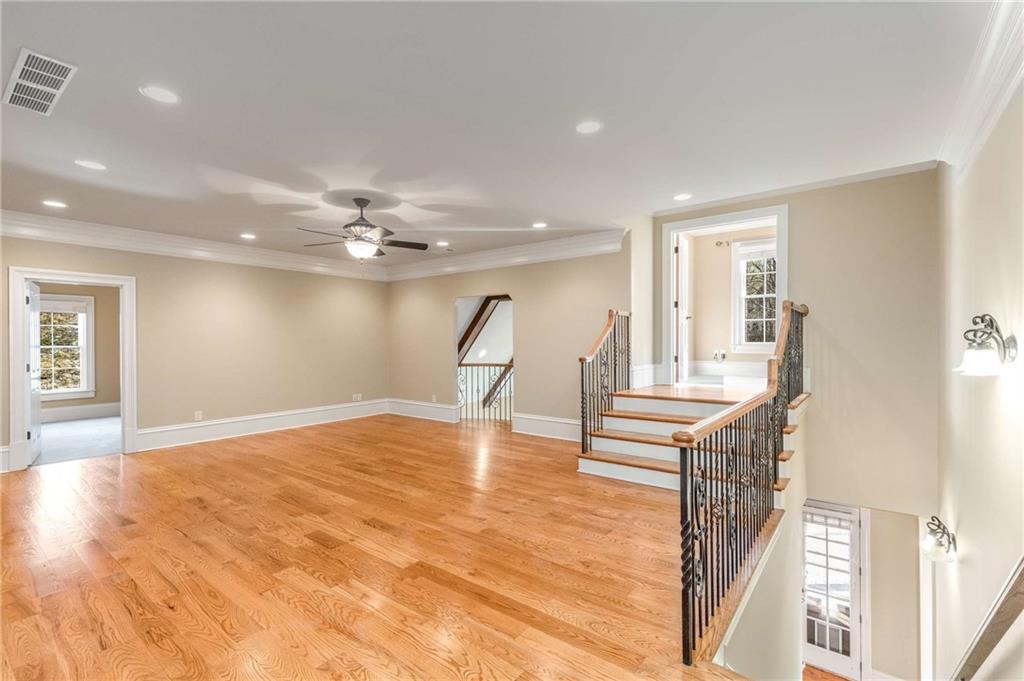 16050 South Thompson Road Milton, GA 30004 - Photo 48 of 72 a view of a livingroom with wooden floor and a ceiling fan