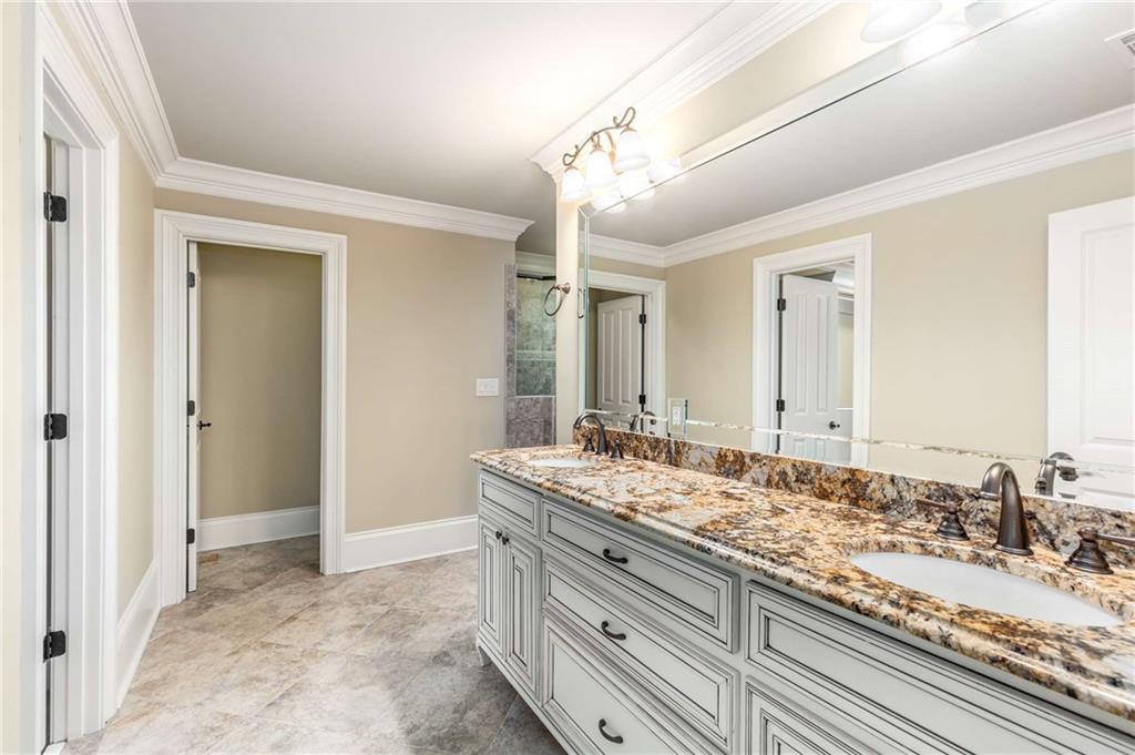 16050 South Thompson Road Milton, GA 30004 - Photo 50 of 72 a bathroom with a granite countertop sink and a mirror
