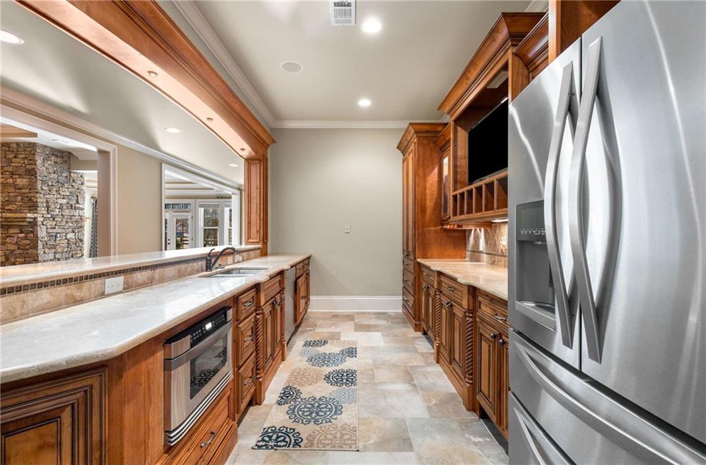 16050 South Thompson Road Milton, GA 30004 - Photo 64 of 72 a hallway with granite countertop a sink and a large window