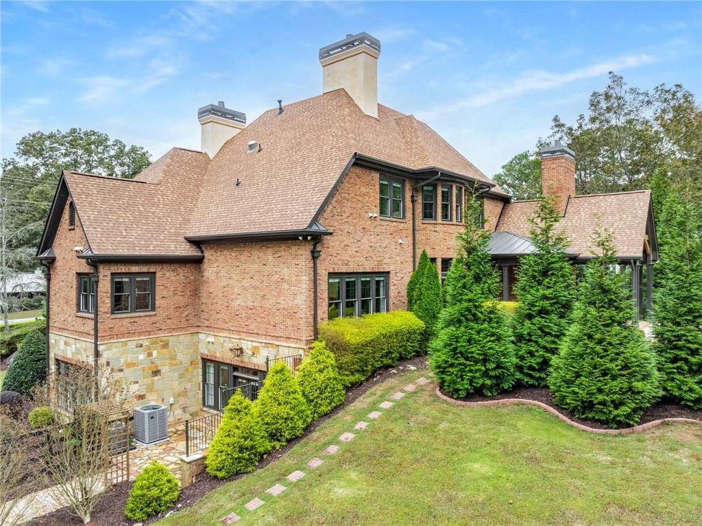 16050 South Thompson Road Milton, GA 30004 - Photo 7 of 72 front view of a house with a yard