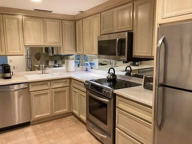 a kitchen with a sink appliances and cabinets