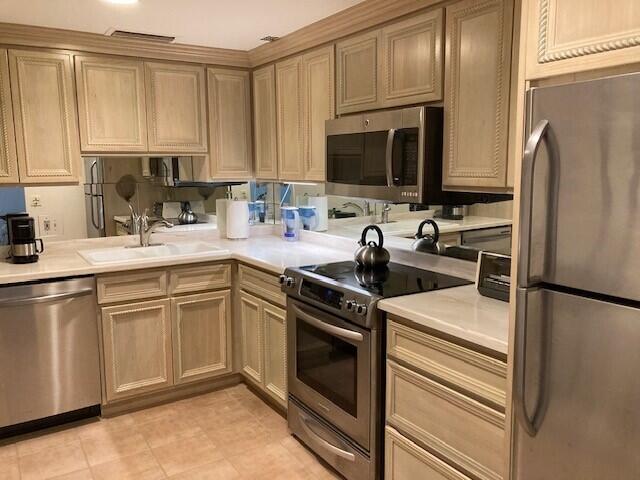 354 Chilean Avenue, Unit 2D Palm Beach, FL 33480 - Photo 6 of 11 a kitchen with a sink appliances and cabinets