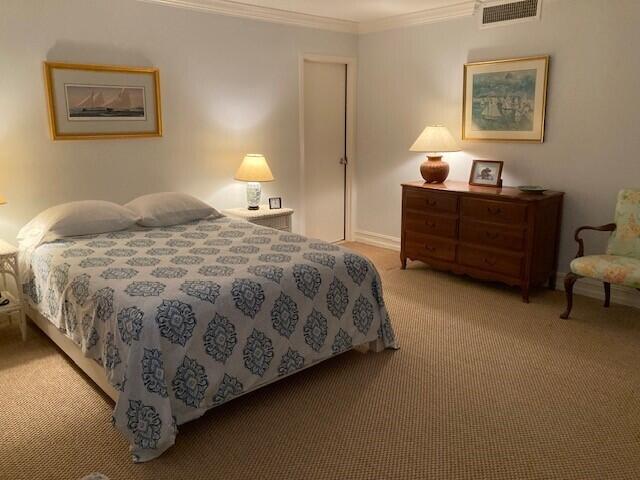 354 Chilean Avenue, Unit 2D Palm Beach, FL 33480 - Photo 8 of 11 a bedroom with a bed and lamp