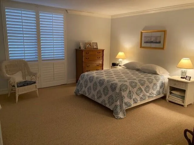 a bedroom with a bed and a chair