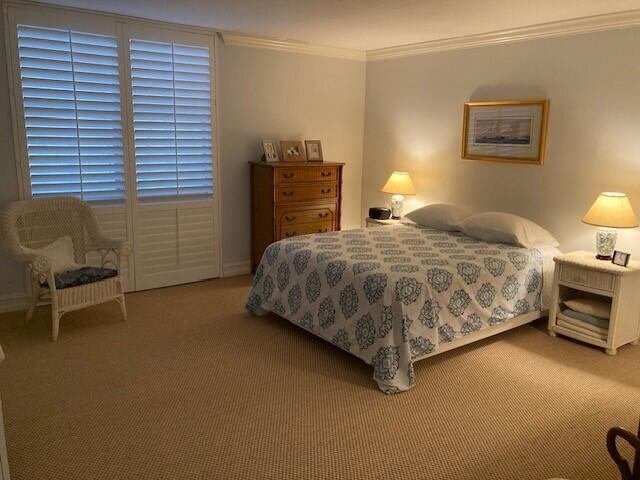 354 Chilean Avenue, Unit 2D Palm Beach, FL 33480 - Photo 9 of 11 a bedroom with a bed and a chair