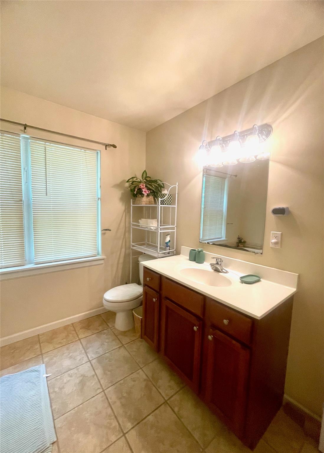 24 3rd Street Middletown, NY 10940 - Photo 15 of 34 a bathroom with a granite countertop sink toilet a mirror and a shower