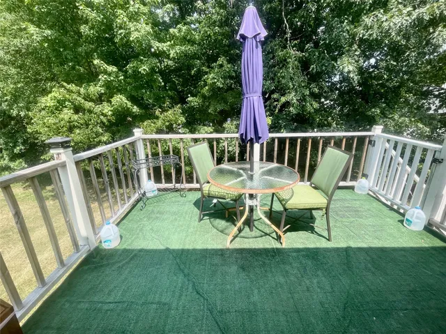 a view of a chair and table in the garden