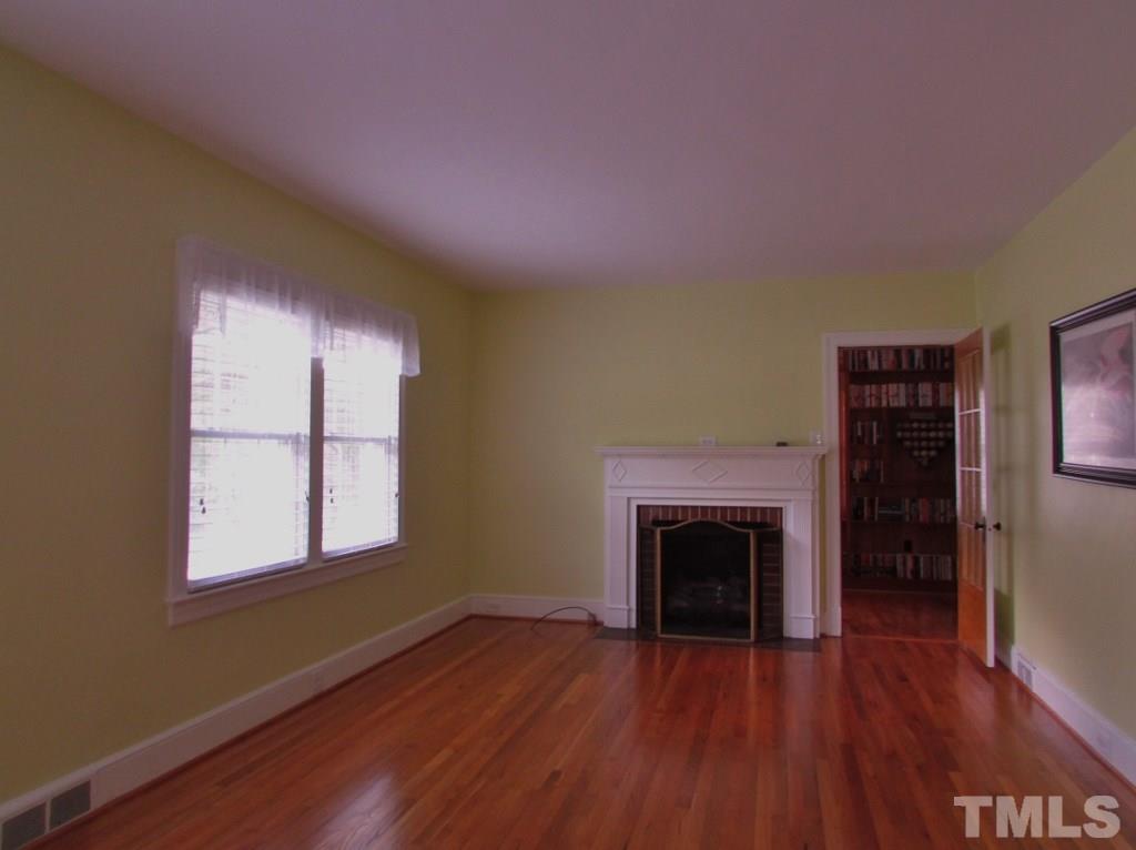 511 Chub Lake Street Roxboro, NC 27573 - Photo 6 of 23 There is a gas log fireplace which one will enjoy during the winter months. The door to the right of the fireplace is to the office.