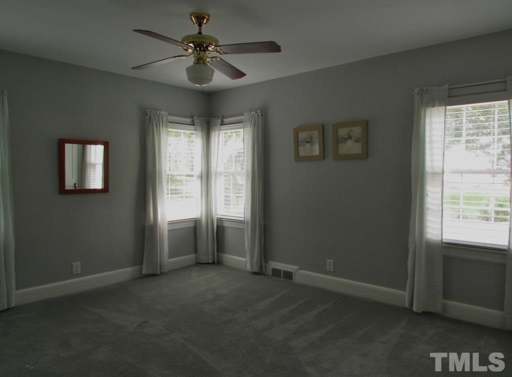 511 Chub Lake Street Roxboro, NC 27573 - Photo 9 of 23 Master Bedroom has carpet, corner windows, dual closets