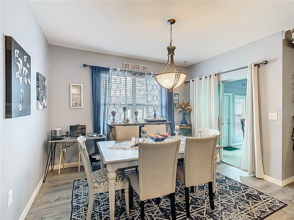 1765 Brockridge Road Kissimmee, FL 34744 - Photo 11 of 45 a view of a dining room with furniture window and wooden floor